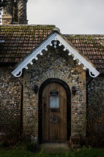 Tiles on roof of a house with rounded door